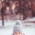 Little Girl Playing in the Winter Snow