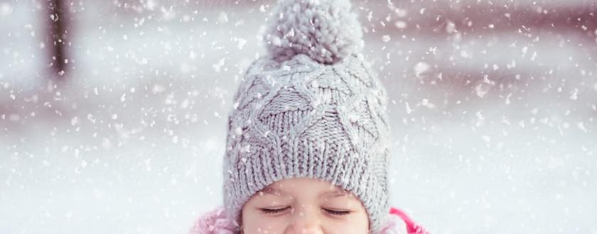 Little Girl Playing in the Winter Snow